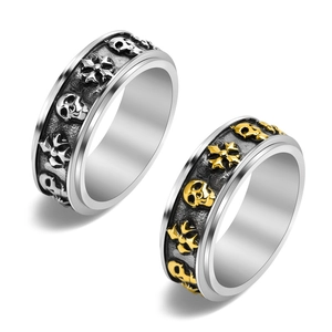 Macro detail of punk skull rings with relief cross patterns in vintage steel