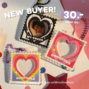 Macro detail of heart-shaped acrylic photo frame keychains with colorful bead chains