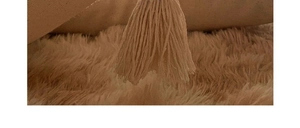 Detailed shot of bohemian tassel fringes on tufted cotton linen pillow cover