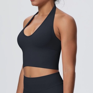 Detail view of black seamless ribbed yoga set featuring halter neck top and high-waist leggings