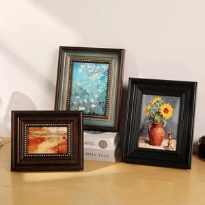 Vintage French art photo frames set with classic oil paintings in a sunlit room setting