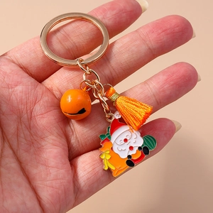 Christmas keychain with golden ring, orange tassel, bell and Santa Claus enamel charm