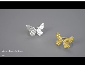 Close-up of vintage butterfly rings in silver and gold with detailed wing textures