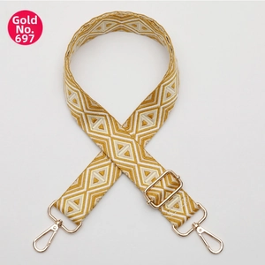 Detail of bohemian yellow diamond pattern woven strap with gold metal swivel hooks