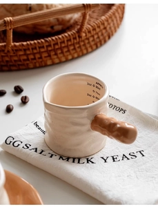 Detailed macro view of ceramic creamer with scale markings and wavy texture