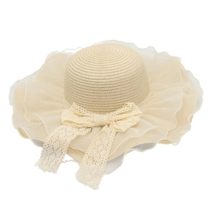 Detail of breathable straw sun hat with organza ruffles and large lace bow decoration