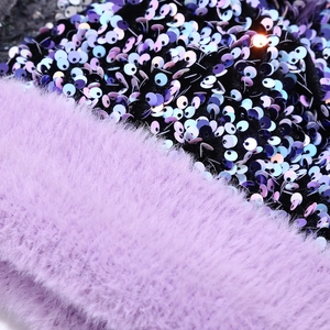 Macro shot of shimmering iridescent sequins on soft purple faux fur winter hat material