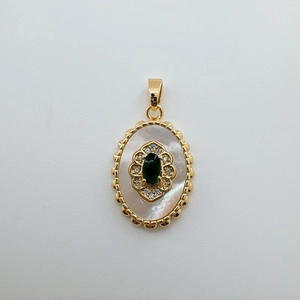Detail of 18K gold-plated oval pendant with white mother-of-pearl and emerald green stone