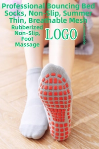 Detail of grey non-slip yoga socks featuring orange grip dots and breathable mesh fabric