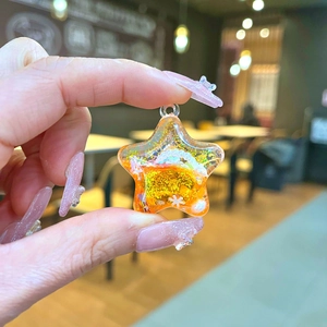 Mini transparent star liquid pendant with orange sand and snowflake sequins