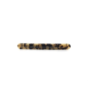 Detailed view of a slender tortoiseshell hair clip with smooth finish and spring clip mechanism