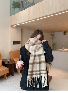 Detail of soft mohair texture and fringe on this beige plaid winter scarf for women