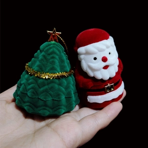 Christmas velvet jewelry box set featuring a green tree and red Santa held by hand