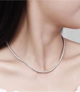 Close-up of 2.5mm moissanite tennis necklace in 925 silver worn on model's neck
