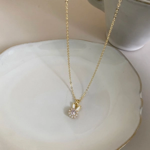 Elegant gold necklace featuring a rabbit pendant with mother-of-pearl and clear zircon stone