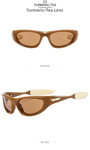 Detailansicht der ingwerfarbenen Sonnenbrille mit Teegläsern und weißen Bügeln