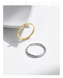 Close-up of gold and silver S925 sterling silver rings with hammered texture and zircon