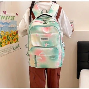 Detail of gradient pink and mint green backpack with stars and butterfly prints