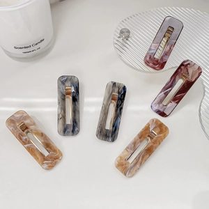 Set of six rectangular acrylic hair clips with marble patterns and gold metal ducks