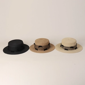 Detailed weave of bowknot mesh band on three straw boater hats for summer vacation