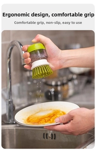 Close-up of a kitchen dish brush cleaning a dirty plate with dense bristles in a sink
