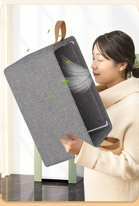 Detail view of a gray fabric storage box with leather handles emphasizing odor-free material