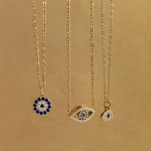 Three gold stainless steel necklaces with blue evil eye pendants and zircon stones