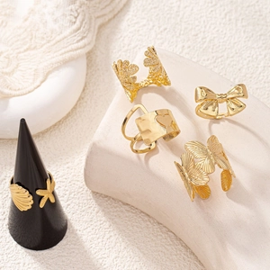 Gold leaf and starfish ring set for women displayed on elegant beige plaster props