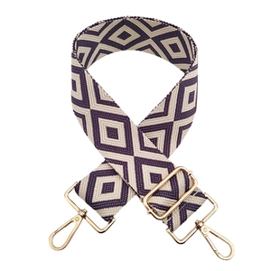 Detailed weave of purple and cream geometric diamond bag strap with gold metal hooks