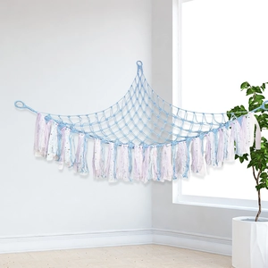 Handmade macrame toy hammock in light blue with colorful tassels for kids room storage
