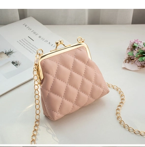 Detail of pink quilted mini bag with gold chain strap and metal ball clasp closure