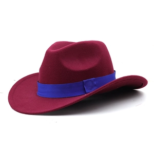 Detailed side view of a wine red fedora hat featuring a striking royal blue ribbon band