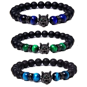 Macro view of men's beaded bracelets featuring stone beads and detailed metal wolf head charms