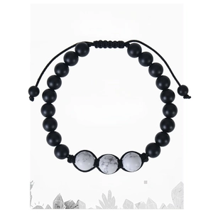 Detail of beaded bracelet with three white howlite stones on a branded message card