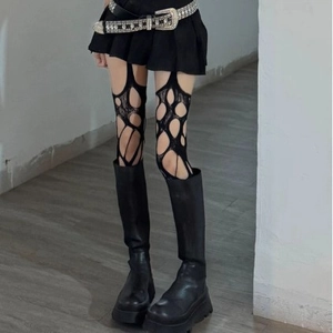 Punk Y2K style black irregular ripped fishnet stockings with chunky platform mid-calf boots