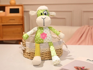 Detail of a patchwork sheep plush toy with colorful patterns in a woven basket