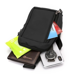 Waterproof black crossbody bag for men showing spacious interior storage with multiple pockets