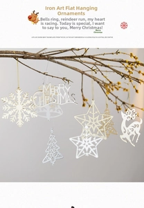 Gold and silver metal snowflake and star ornaments hanging on branches for Christmas decor