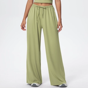 Detail of high-waisted wide-leg trousers featuring elastic waistband and adjustable drawstrings