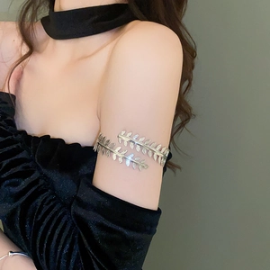 Detail view of silver leaf arm cuff on upper arm showcasing adjustable double branch design