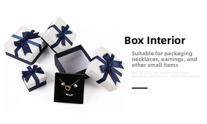 Detail of jewelry gift box with blue ribbon bow and black velvet foam insert