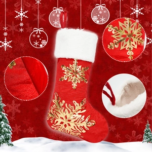 Close-up of red Christmas stocking with golden sequin snowflake embroidery and white fur trim