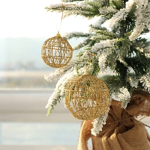 Golden iron Christmas balls with glitter hanging on a snowy tree for festive decoration