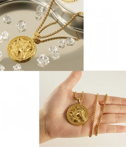 Macro shot of 3D horse head pendant with Greek key pattern on gold stainless steel box chain