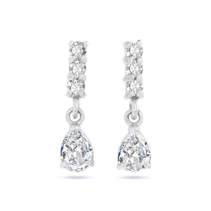 Macro view of silver drop earrings featuring round diamonds and pear-shaped zircon stones