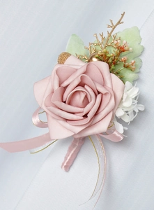 Detailed view of dusty pink PE rose boutonniere with golden berries and ribbon