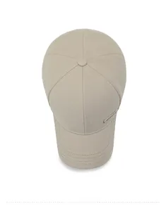 Vue de dessus d'une casquette beige minimaliste avec texture sergé et logo métallique latéral