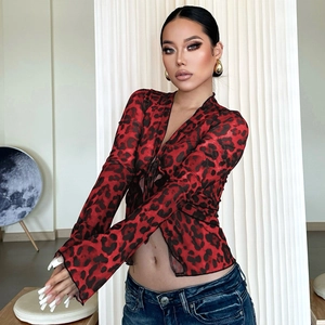 Detail of red and black leopard print mesh top with tie-up front and flared long sleeves