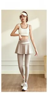 Detailed shot of white sports tank top and coffee brown skirt leggings yoga set