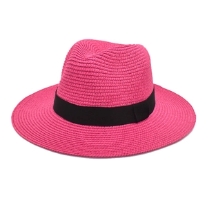 Detailed view of pink straw fedora with fine weave and classic black ribbon trim